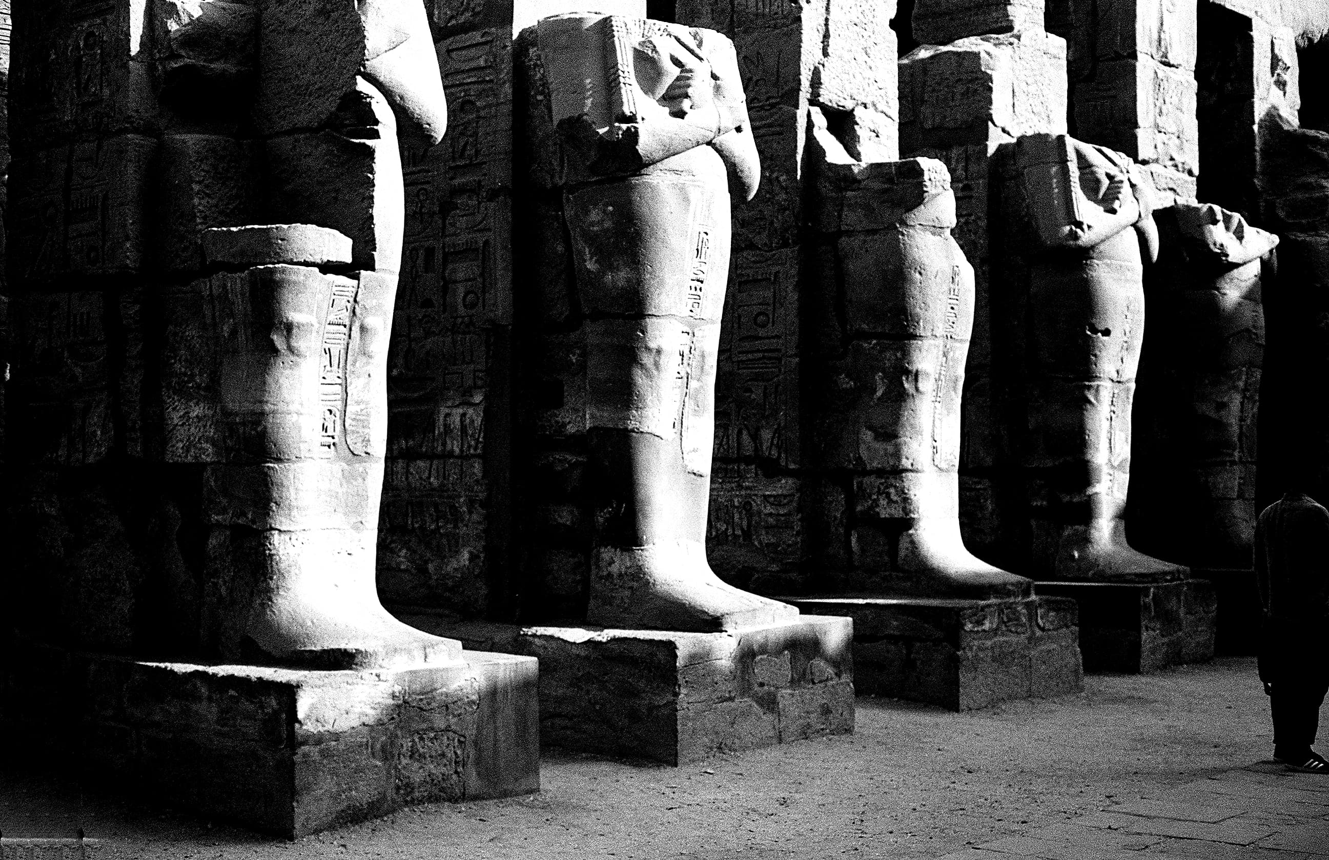 Ancient Egyptian figures standing in temple light