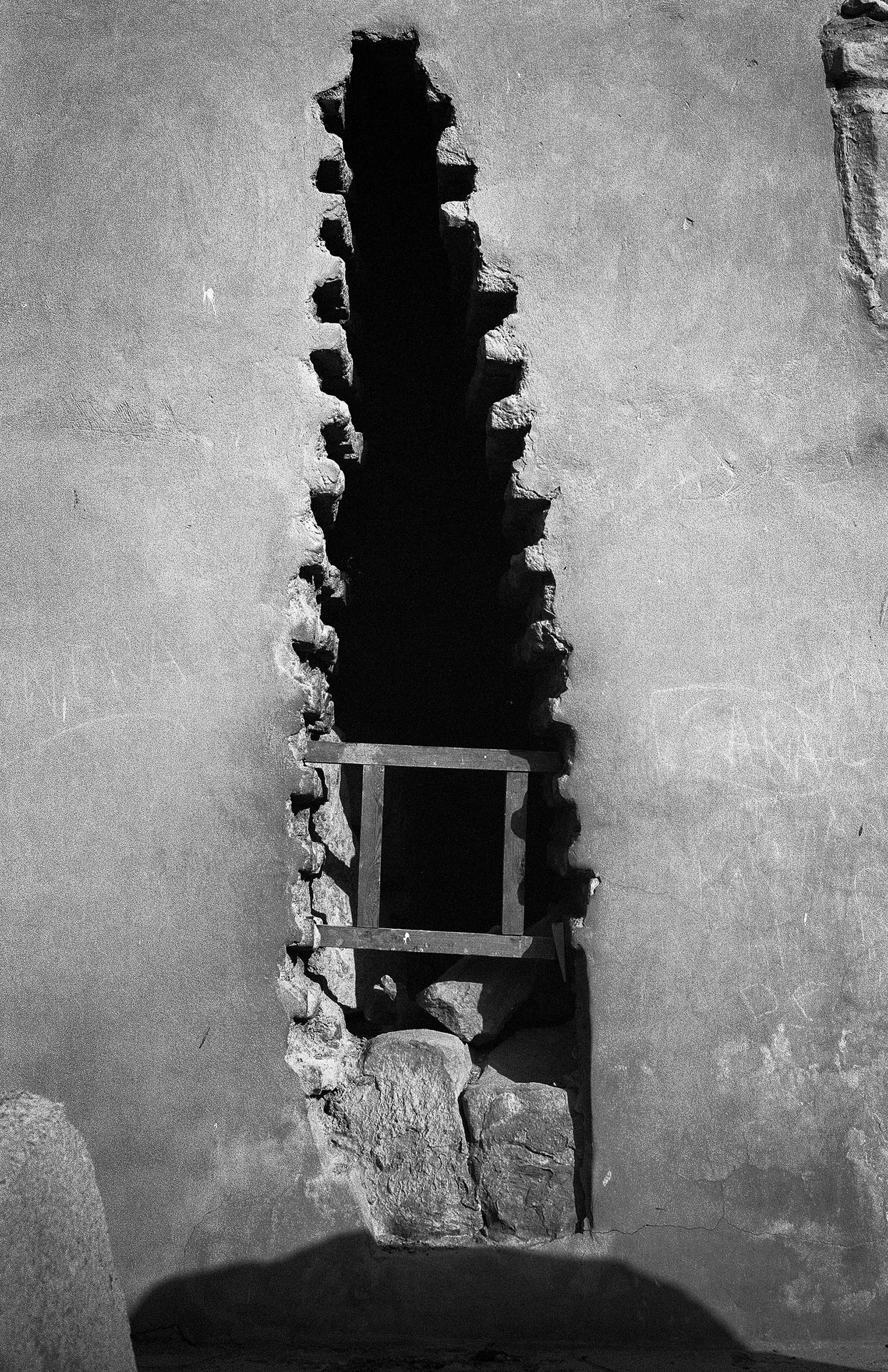 Narrow opening in a weathered stone wall
