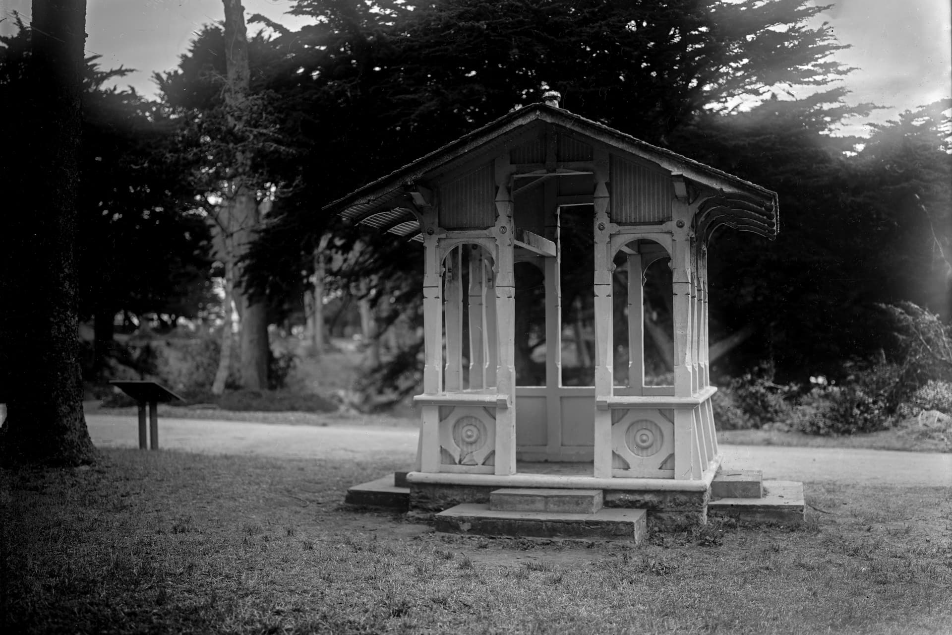 Small ornamental pavilion in a wooded park, photographed in monochrome