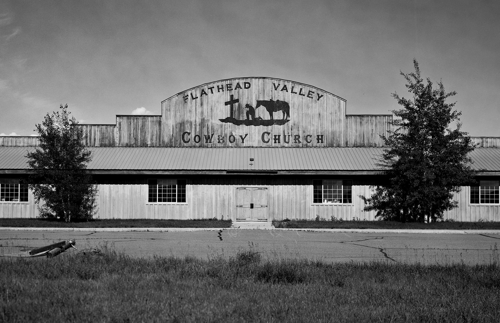 Flathead Valley Cowboy Church rustic wooden building with praying cowboy and horse silhouette
