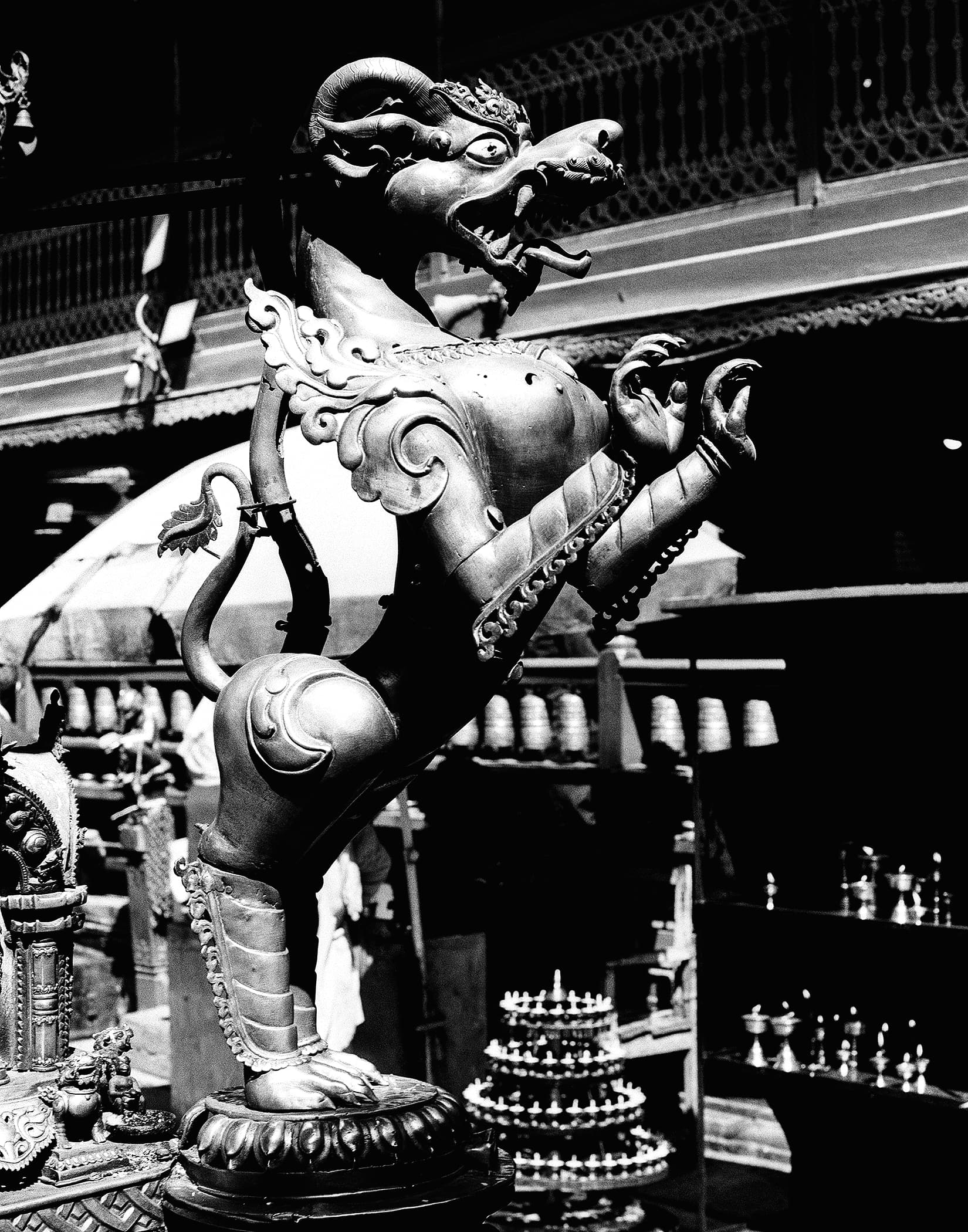 Bronze mythical creature statue rearing in a temple courtyard