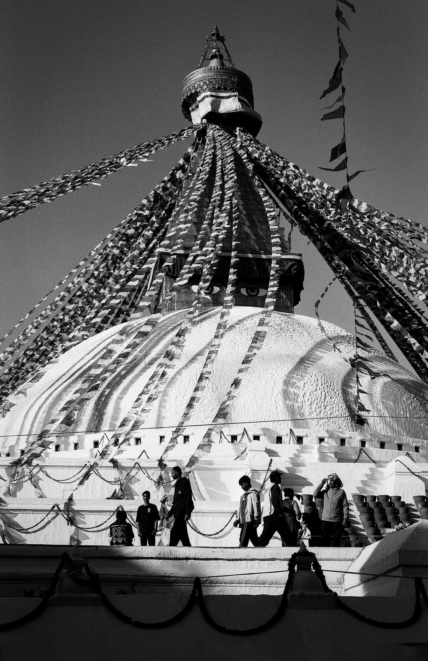 Crowded square beneath the decorated dome of a stupa