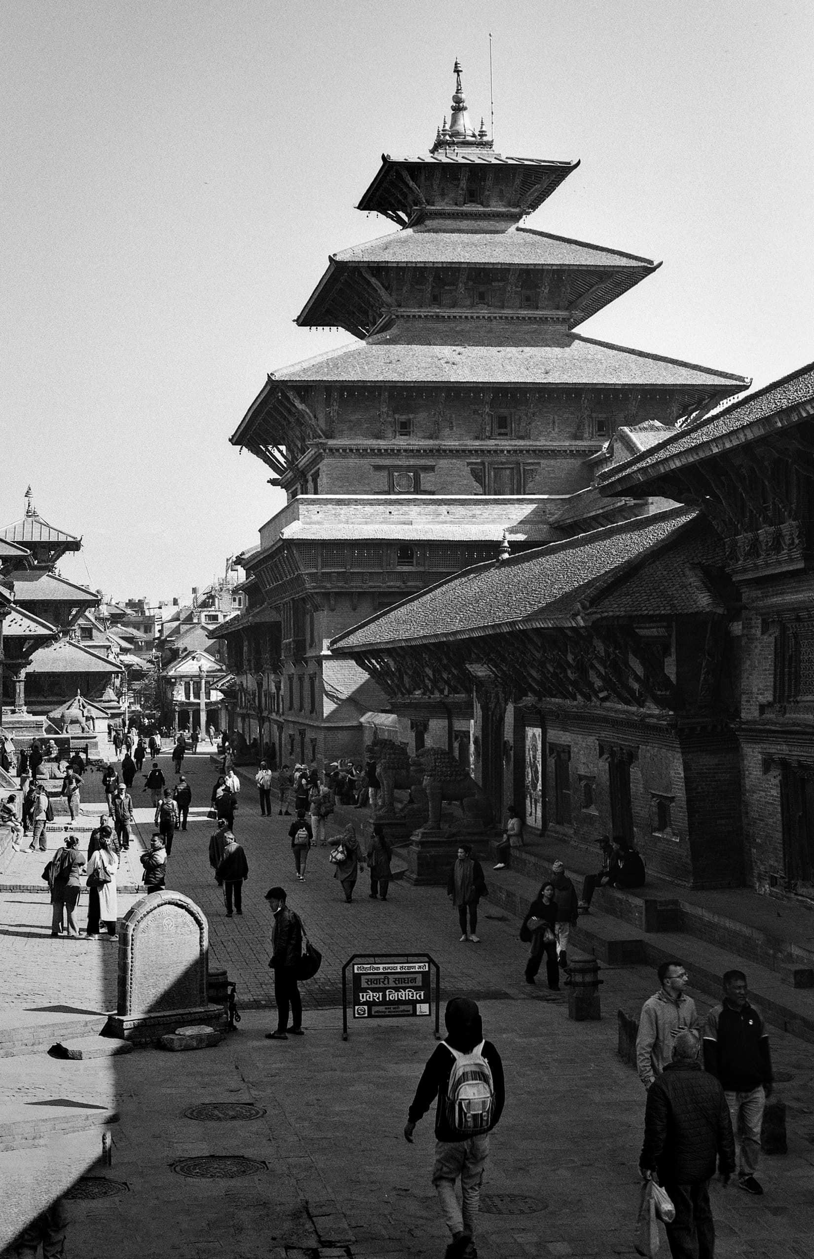 Tall pagoda temple rising above a busy historic square