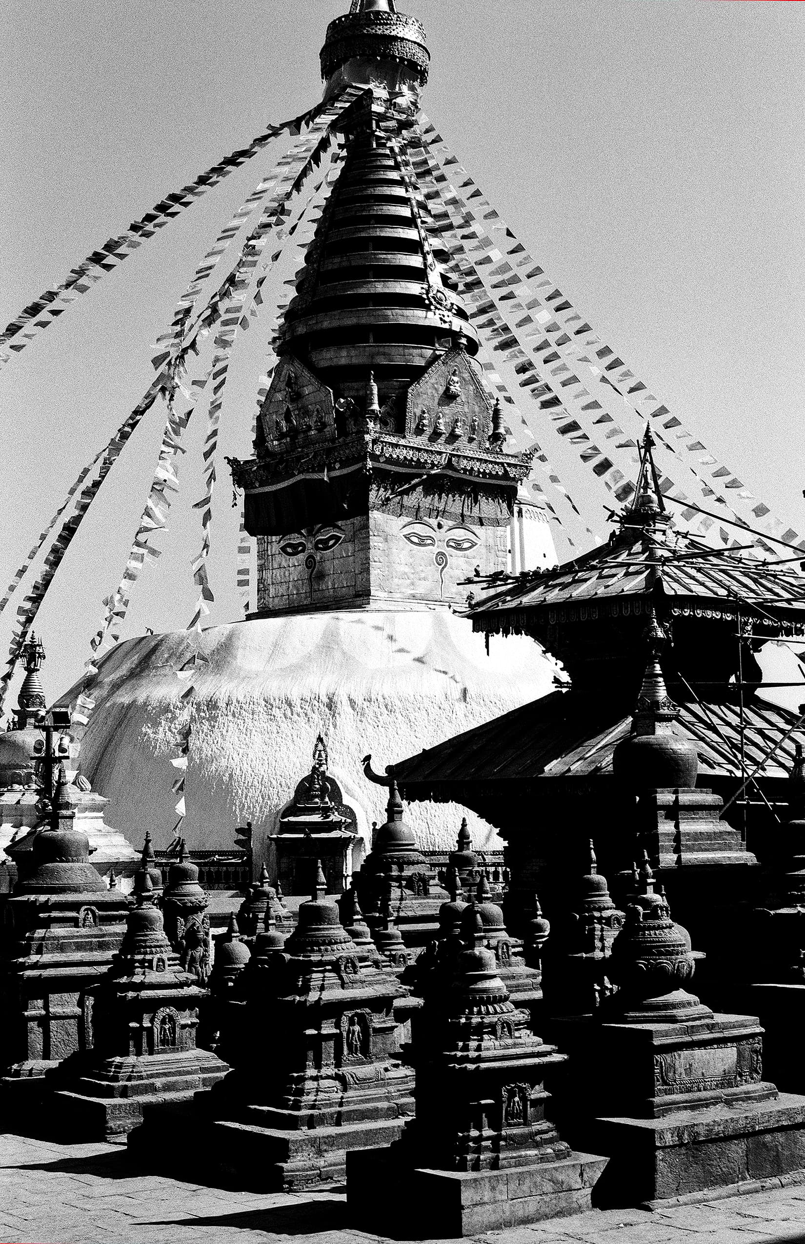 Large temple bell hanging beneath an ornate stone arch