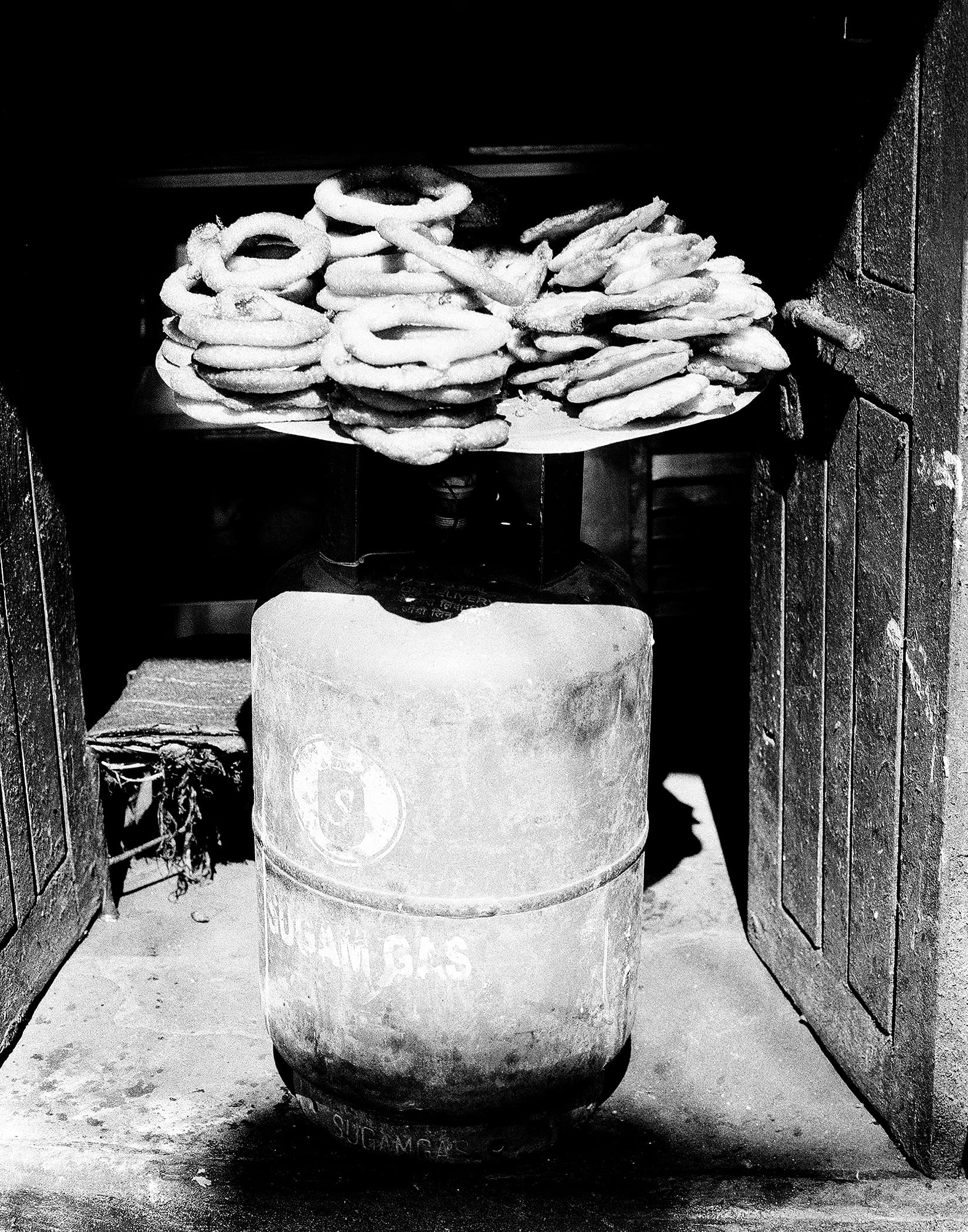 Stack of fried street snacks displayed on a weighing scale