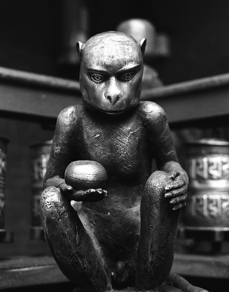 Bronze monkey statue with prayer wheels in Nepal